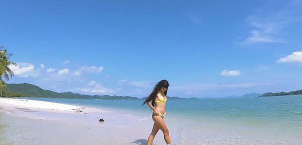  Micro bikini tease by sexy teen who walks on a beach